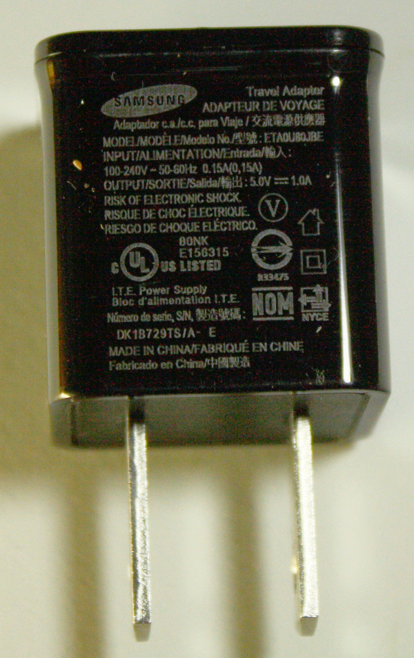 The charger of my phone says input: 100-240V 50-60Hz 0.15 A and output: 5.0  V=1.0 A. I'm from Europe. If I go to the US, will I need just an adapter or