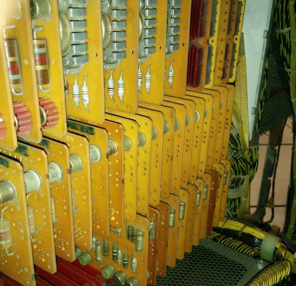 A closeup of SMS cards inside an IBM 1406 Storage Unit. The top cards have heat sinks on high-current driver transistors.