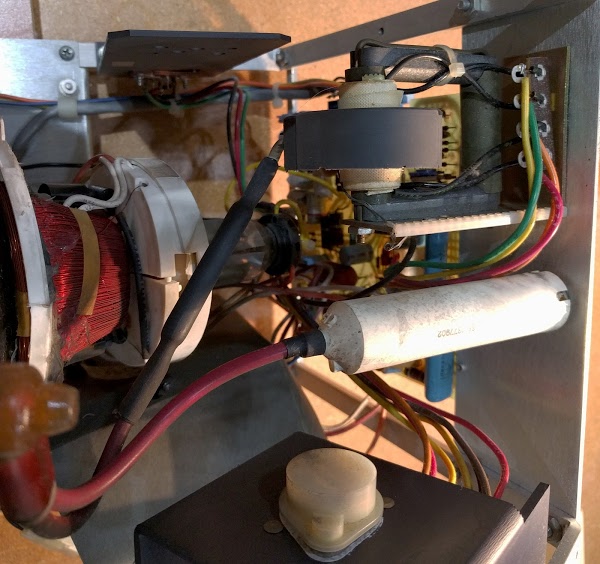 The CRT tube in the Alto's monitor, showing the deflection coils around the tube. The flyback transformer is in the upper right. The bleeder resistor is on the right.