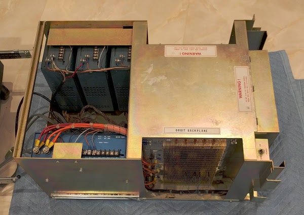 The Alto's chassis has been removed. On the left are the four switching power supplies (blue boxes). On the right, the connections for the wire-wrapped backplane are visible. The circuit boards plug into this backplane.