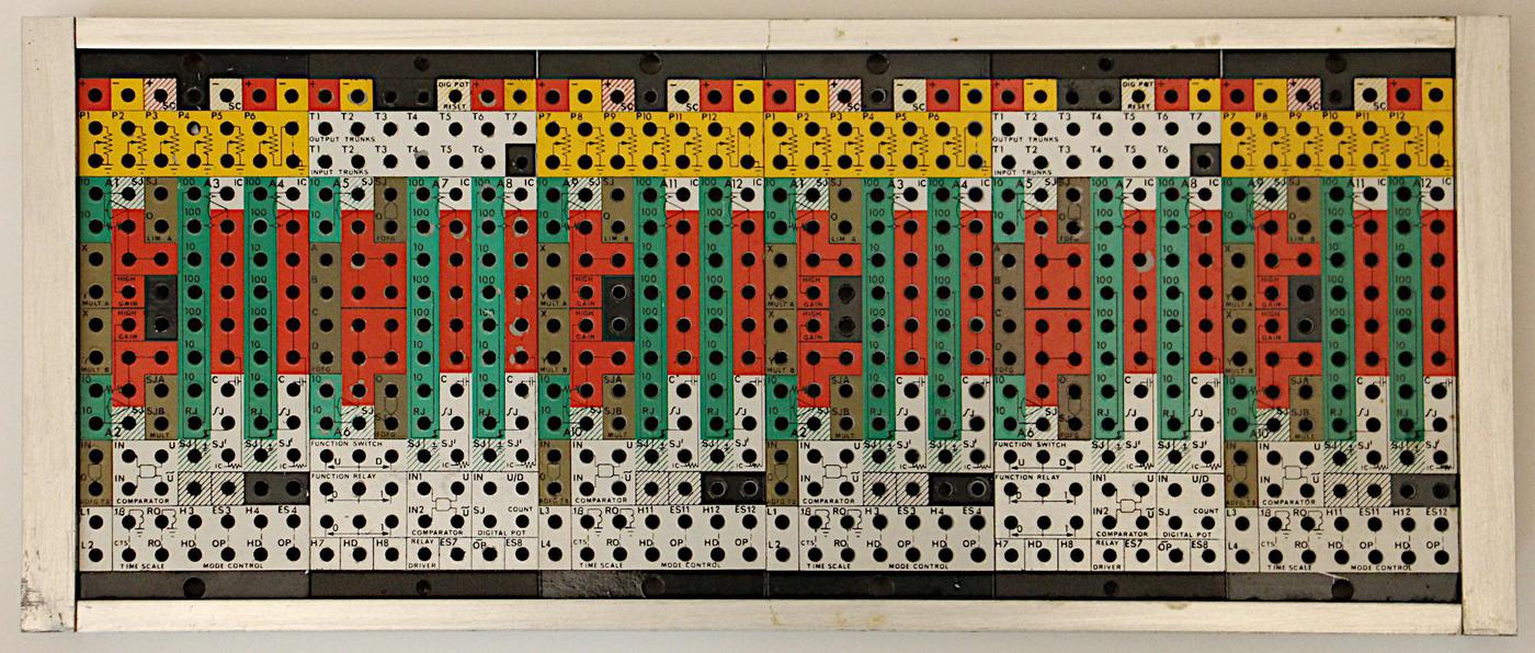 The removable patch panel for the analog computer. The computer was programmed by plugging wires into the holes. 
The panel is removable, so one programmer could use the analog computer while another is wiring up a panel.
(Click to enlarge.)