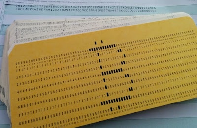 The Bitcoin symbol on an IBM punched card.