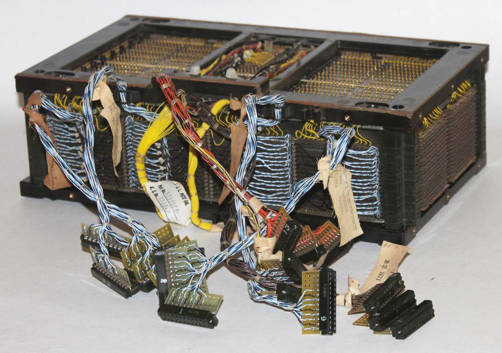 A 64 KB core array from the IBM S/360 Model 50. There are 18 core planes stacked front-to-back. The blue cables are the sense/inhibit lines. Driver cards are plugged into the front of this array.