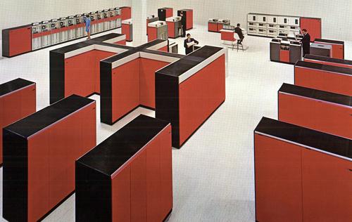 Large computer room with an IBM System/360 Model 85. The CPU, the double-H unit in the center, weighed over 7 tons.
Cabinets in front are core memory storage, holding 256 kilobytes each.
Cabinets on the right are I/O channels, connected to I/O devices at the back:
tape drives, printers, disk drives, and card readers. Photo from IBM.