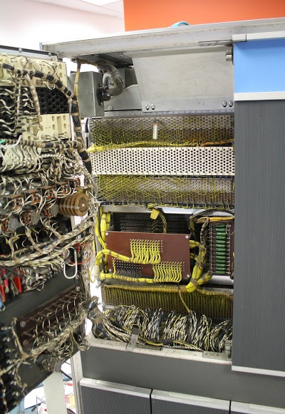 Opening the console panel (left) of the IBM 1401 mainframe shows the 4K core memory unit (center).