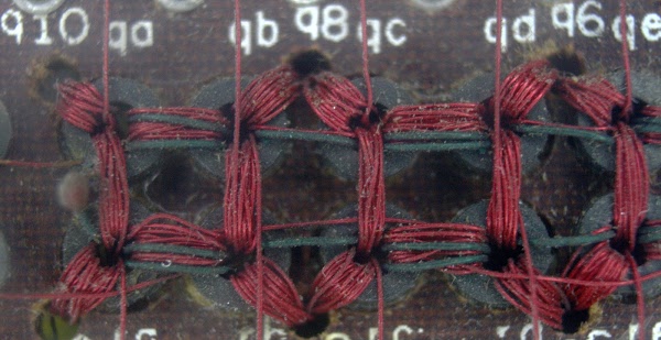Closeup of the matrix switch used in the IBM core memory.
Each ferrite ring drives one of the select lines in the core memory.