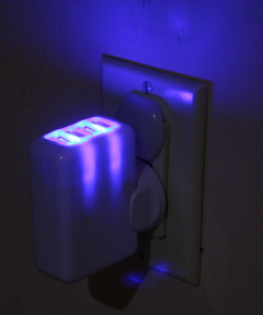 The KMS 4-port USB charger emits an eerie blue glow when in use.
