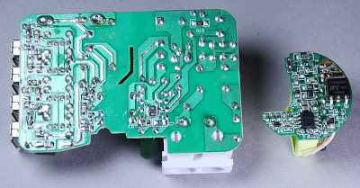 The circuit board from the KMS-AC09 charger on the left and a circuit board from the HP TouchPad charger on the right. Note the much higher density of the TouchPad board.