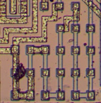 The LM308 op amp contains several resistors with resistance than can be modified by changing the metal layer. This image shows one resistor with about 20 segments. A few of the segments are shorted out with metal, reducing the resistance.