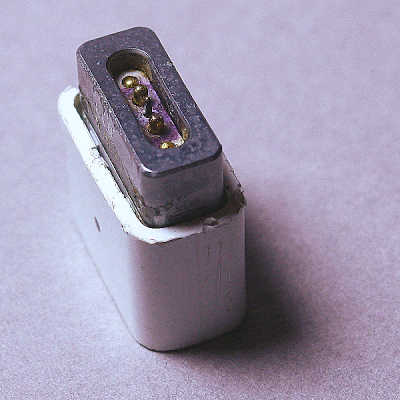 A Magsafe connector with burnt pins.