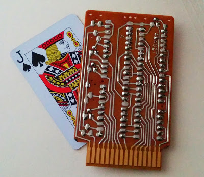 An IBM SMS card (type DGU) with a playing card for scale.