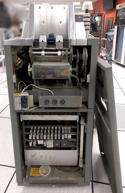 Inside the IBM type 83 card sorter. At top is the card feed. The cams are behind clear plastic.