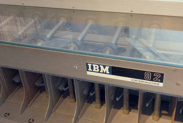 IBM Type 82 Card Sorter. The feed rollers under the glass top send cards through the sorter. The pockets at bottom collect the cards. This is a German model, thus the 'Sorteirmaschine' label.