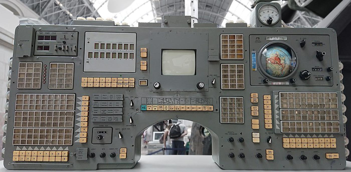 Control panel from a Soyuz spacecraft. The digital clock is in the upper left of the panel. The screen in the middle is a TV monitor. Photo from Stanislav Kozlovskiy, CC BY-SA 4.0.