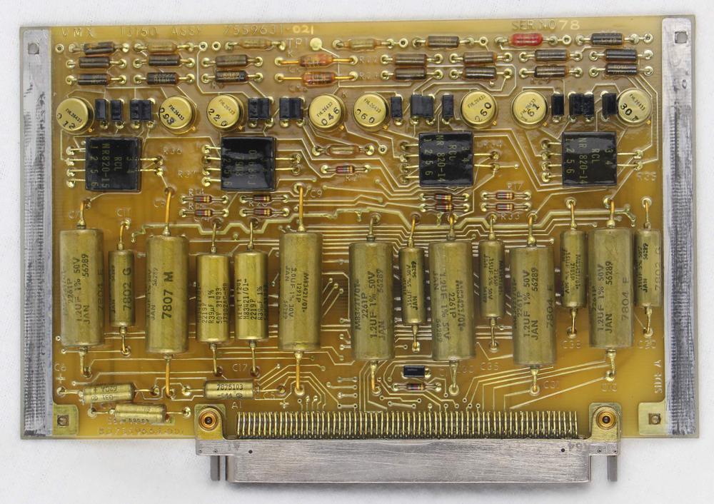 The VMX interface board. Like the other boards, it is covered with a thick conformal coating.  The connector at the bottom is much narrower than the connectors on the digital boards.