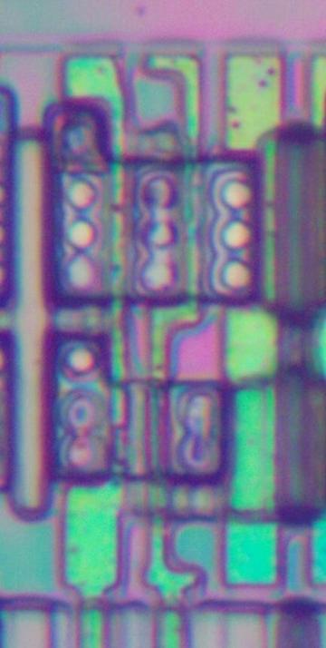 Die photo of the NAND standard cell with the metal layers removed. The image isn't as clear as I would like, but it was very difficult to remove the metal without destroying the polysilicon.