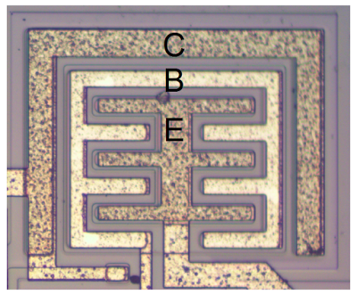 A large, high-current NPN output transistor in the 555 timer chip. The collector (C), base (B) and emitter (E) are labeled.