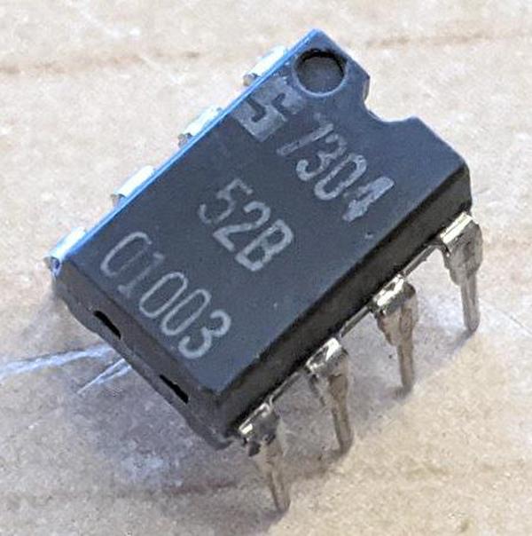 An 8-pin 555 timer with a Signetics logo. It doesn't have a 555 label, but instead is labeled "52B 01003" with a 7304 date code, indicating week 4 of 1973. Photo courtesy of Eric Schlaepfer.