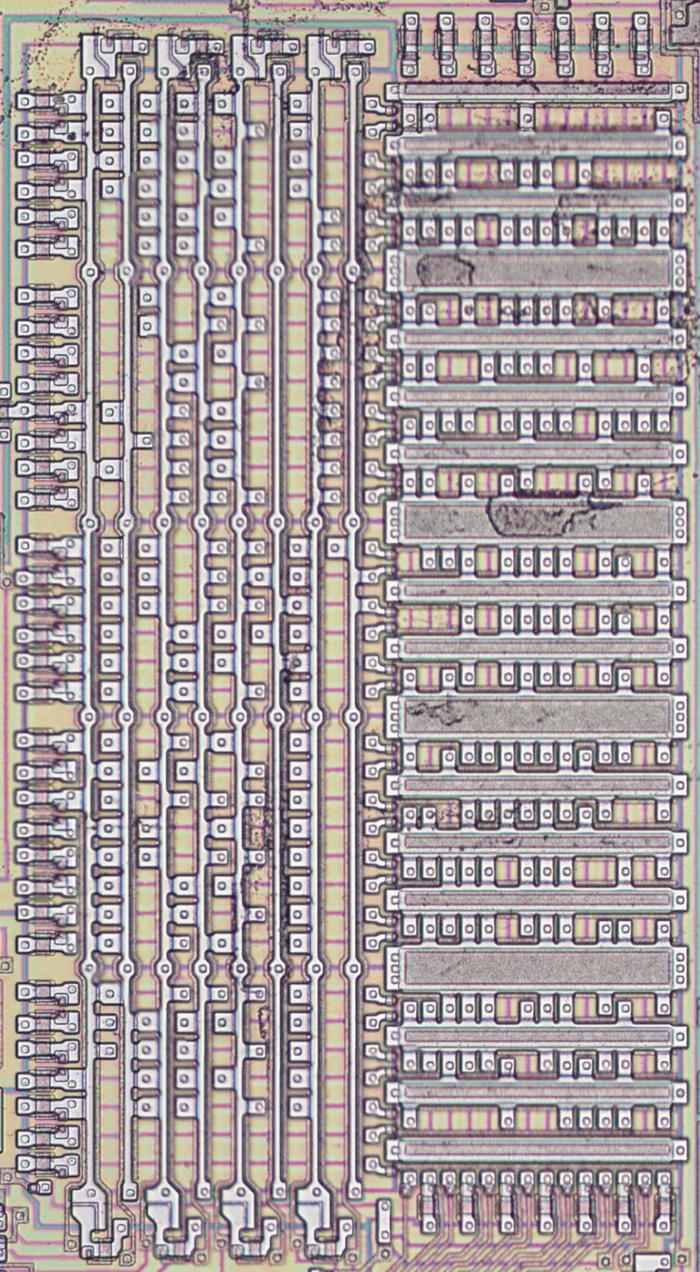 The Translation ROM as it appears on the die. The metal layer has been removed to expose the silicon and polysilicon underneath. The left half decodes the inputs to select a row. The right half outputs the corresponding microcode address.