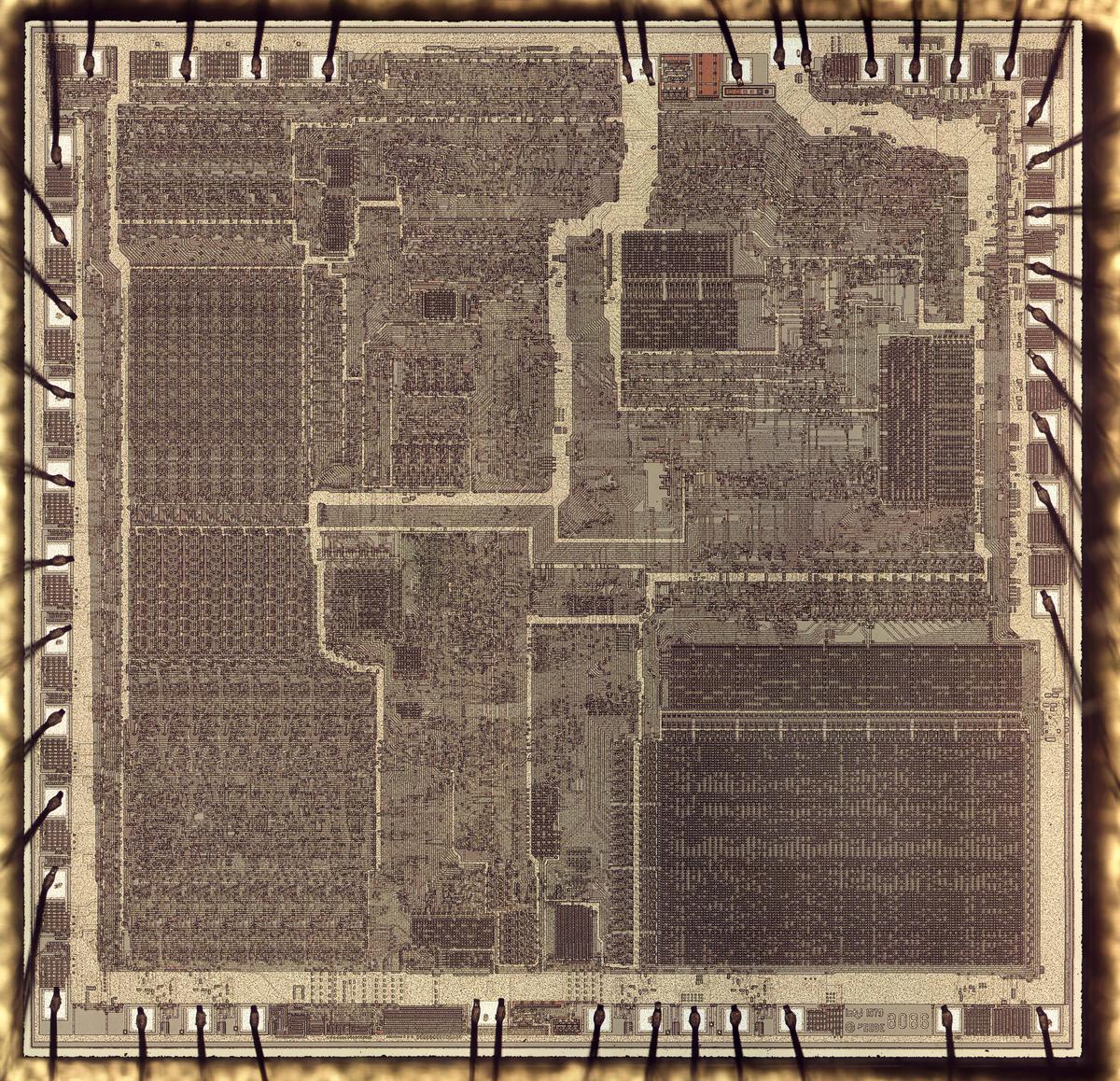 A die photo of the 8086 processor. The metal layer on top of the silicon is visible. Around the edge of the chip, bond wires provide connections to the chip's external pins. Click this image (or any other) for a larger version.