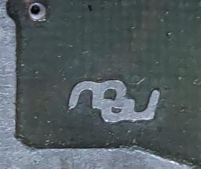 Closeup of a circuit board showing the "mw" mark.