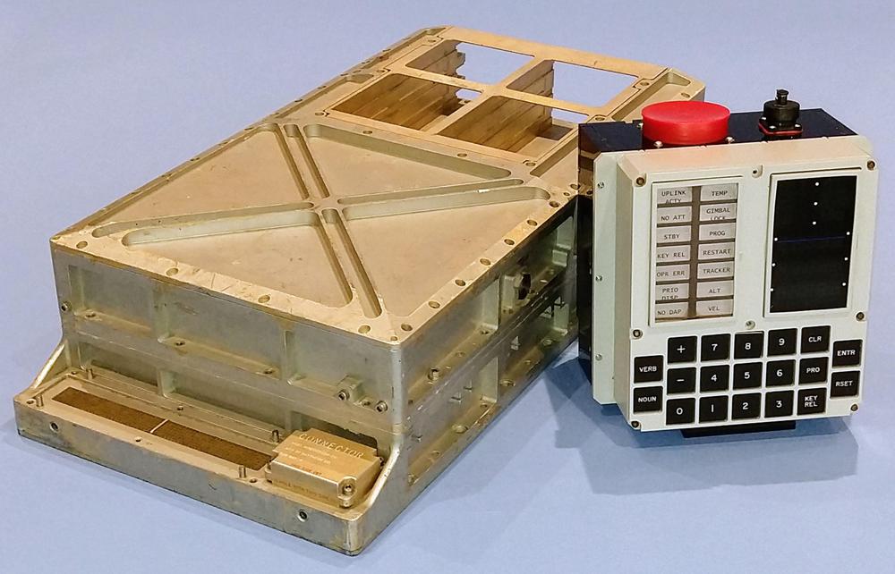 Our Apollo Guidance Computer and replica DSKY. The computer's I/O connectors are visible at the front of the computer. six core rope slots at the back are empty. The photo is an homage to this classic AGC photo.