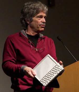 Alan Kay with a mockup of the Dynabook. Photo by Marcin Wichary,  CC BY 2.0.
