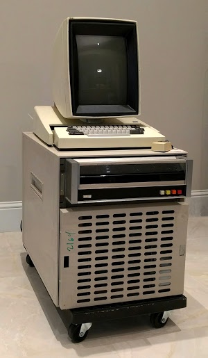 The Xerox Alto II XM computer. Note the video screen is arranged in portrait mode. Next to the keyboard is a mouse. The Diablo disk drive is below the keyboard. The base contains the circuit boards and power supplies.