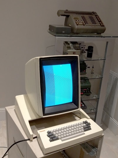 The Xerox Alto running a CRT test program. Antique mechanical calculators are in the background.
