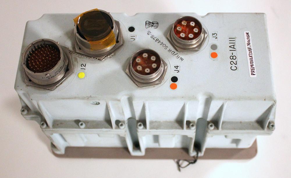 The premodulation processor is a bluish box with four round connectors on top.