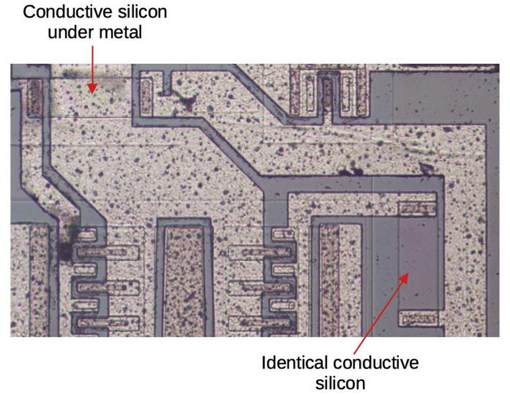 The conductive silicon strip at the top connects the metal regions on either side. The conductive strip at the bottom doesn't fulfill a wiring need, but ensures that both paths encounter the same resistance.