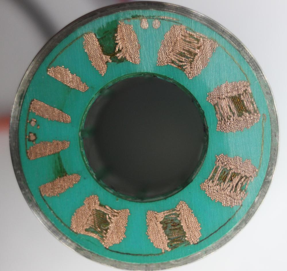 A cross-section of the stator, formed by sanding down the plastic on the end.