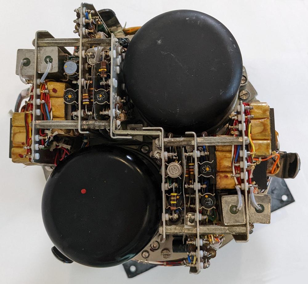 This end-on view of the CADC shows the pressure transducers, the black cylinders. Next to each pressure transducer is a complex amplifier consisting of multiple boards with transistors and other components. The magnetic amplifiers are the yellowish transformer-like components.