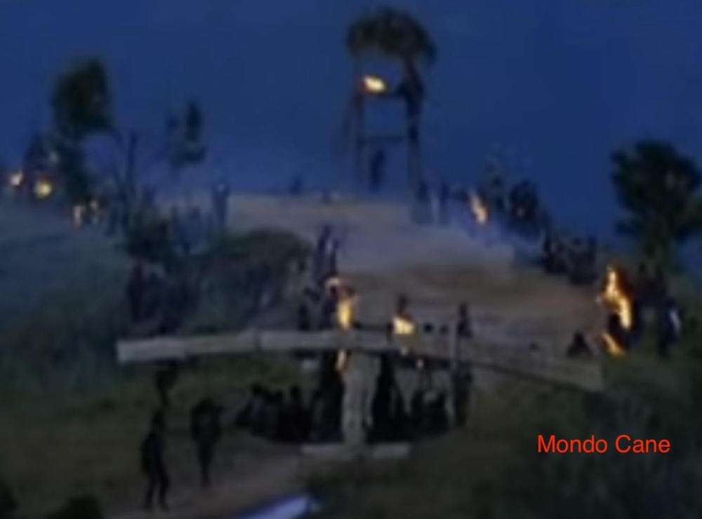 A still from the 1962 movie "Mondo Cane", showing a bamboo airplane sitting on a runway, with flaming torches acting as beacons. I have my doubts about its accuracy.