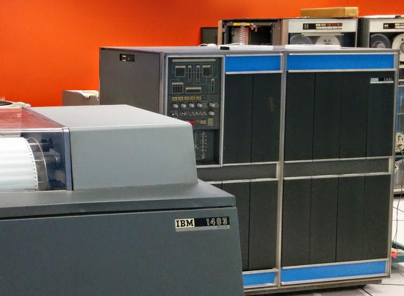 An IBM 1401 computer. The line printer (1403) is in the foreground, while IBM 729 tape drives are in the background. This computer is at the Computer History Museum.