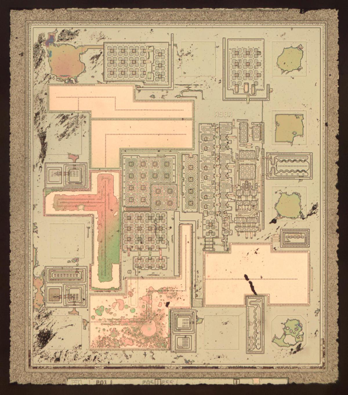 Die photo of the oscillator chip with metal removed to show the polysilicon and silicon underneath.