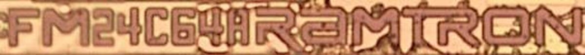 Closeup of the logo "FM24C64A Ramtron" on the die.