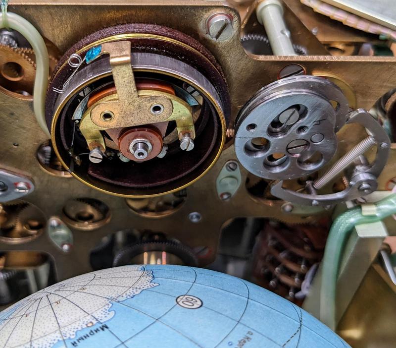 The potentiometer converts the orbital position into a voltage.
To the right is the cam that produces the longitude display. Antarctica is visible on the globe.