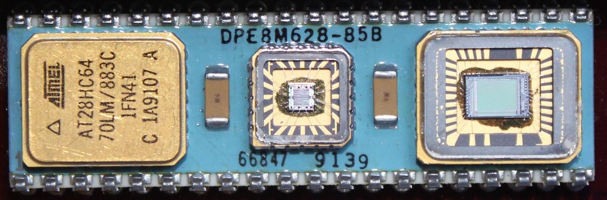 The multi-chip module containing the decoder chip along with an AT28HC64 EPROM on either side.