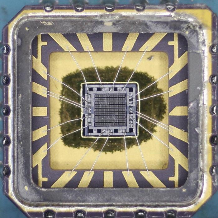 A photo of the tiny silicon die in its package.  This chip is the IDT 54FCT139ALB dual 1-of-4 decoder.  Click this image (or any other) for a larger version.