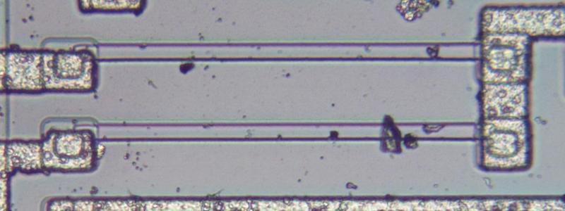A resistor inside the LM185 chip. The resistor is a strip of P silicon between two metal contacts.