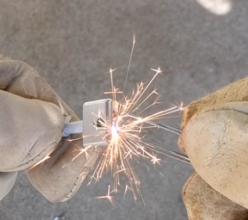 Shorting a cheap charger with a paperclip creates impressive sparks.