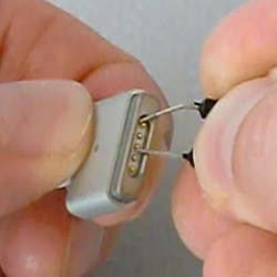 The 64-bit ID can be read out of a Magsafe connector by probing the outer pin with ground, and the middle pin with the 1-Wire data line.