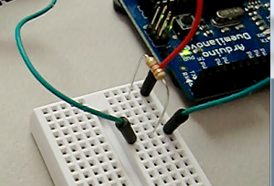 The circuit to access a 1-Wire chip from an Arduino is trivial - just a 2K pullup resistor.