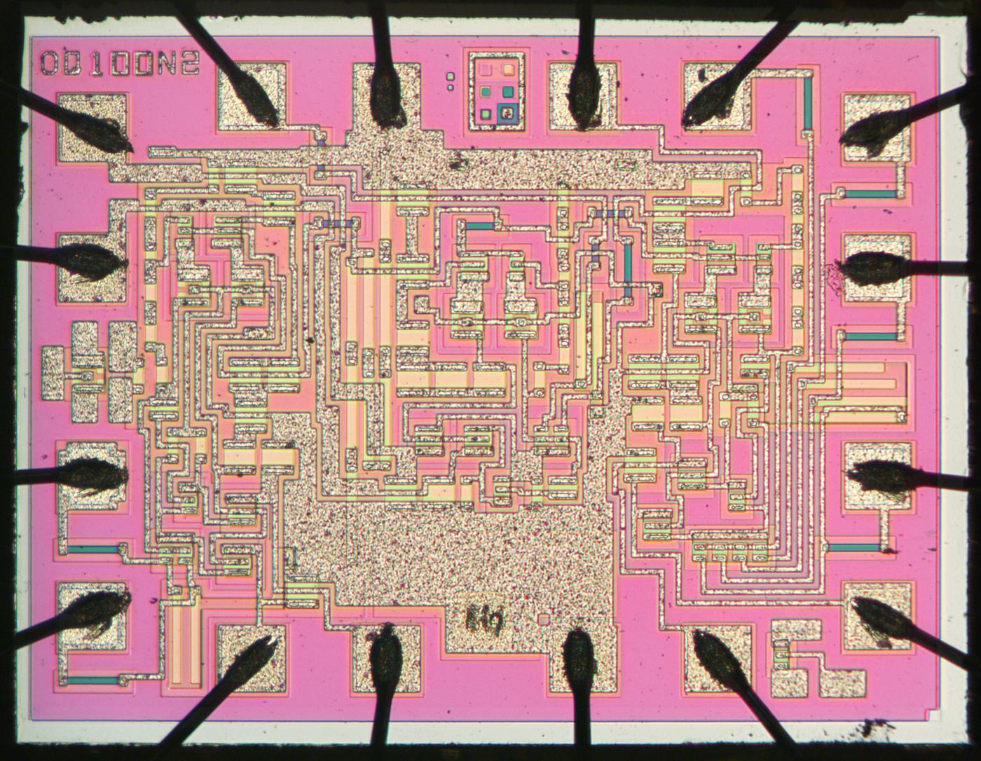 Die photo of the Philips QC100 chip. Click this photo (or any other) for a larger version. Photo courtesy of EvilMonkeyDesignz.