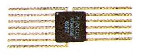 The Fairchild 9040 packaged in a 13-pin flatpack integrated circuit. The chip was also available in a 14-pin DIP, a standard way of packaging chips. Photo from the commemorative brochure.