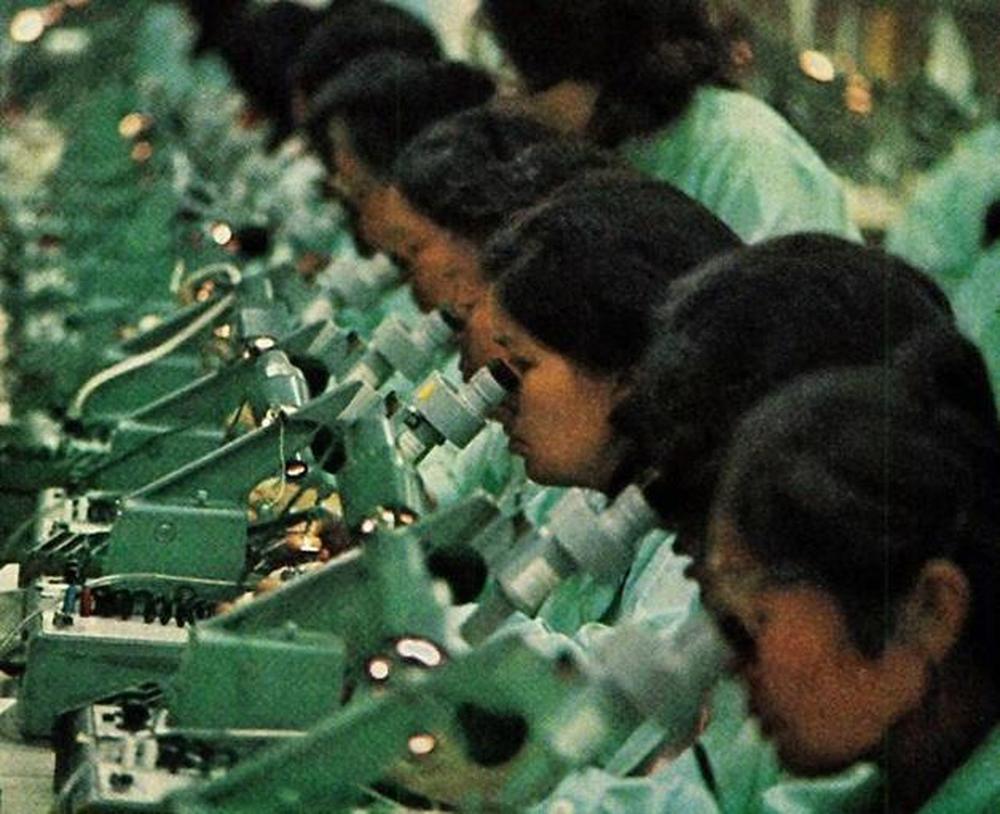 Navajo workers using microscopes in Fairchild's Shiprock plant. From "The Navajo Nation Looks Ahead", National Geographic, December 1972.