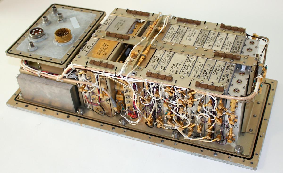 The Apollo Service Module's transponder with the lid removed, showing the circuitry inside. The transponder returned the ranging signal to Earth, multiplying the frequency by exactly 240/221.