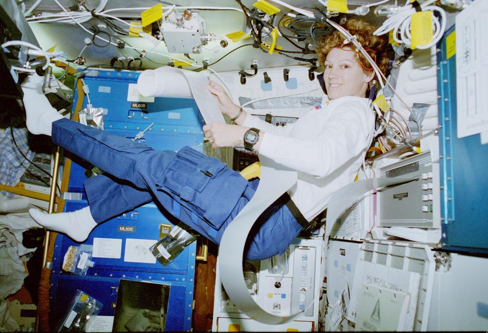 Pilot Collins reading output from the TIPS printer, the gray box on the right. This is flight STS-84, Atlantis. Photo from National Archives.