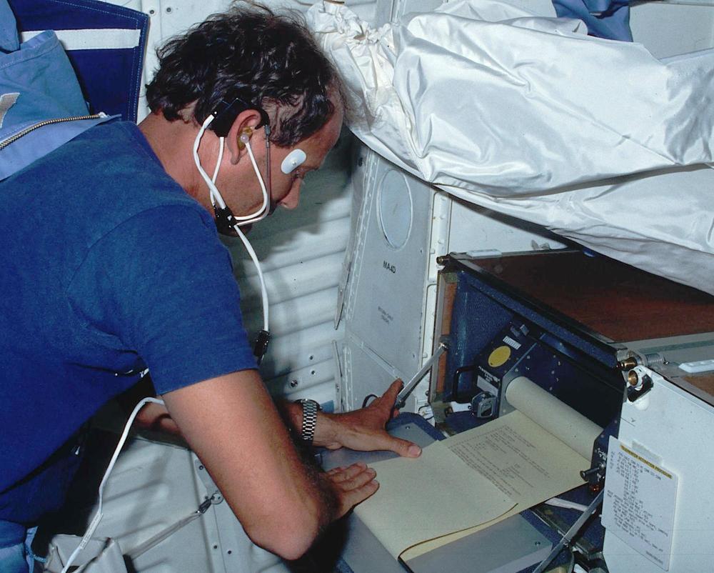 Mission Specialist Thagard getting output from the teleprinter. Flight STS-7, June 24, 1983. From NARA. Although the description says this is the Text & Graphics System, it is clearly the Interim Teleprinter.